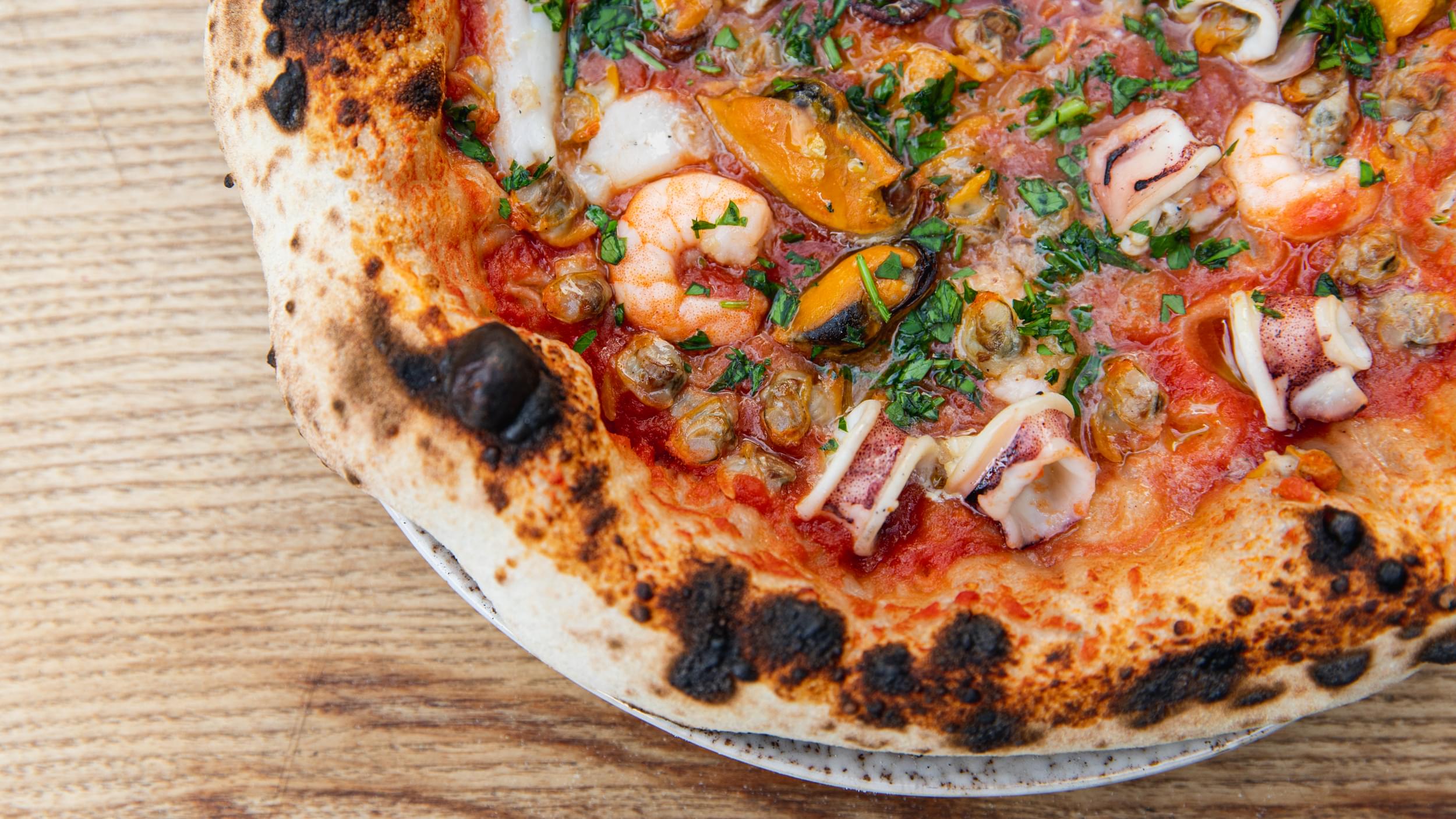Wood-fired seafood pizza with prawns