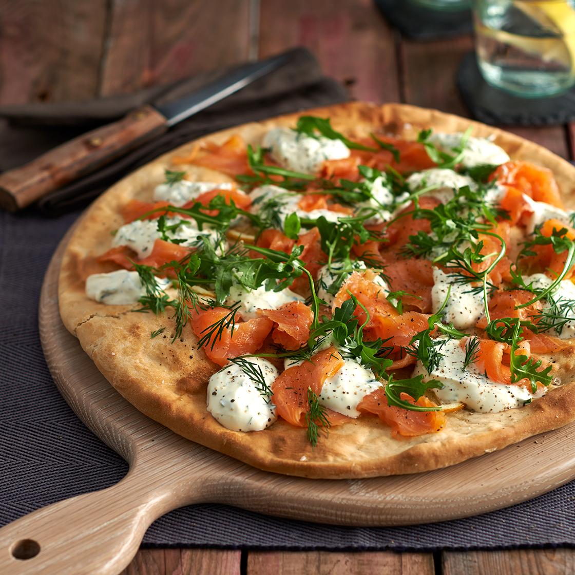 Smoked salmon pizza with crème fraîche and dill