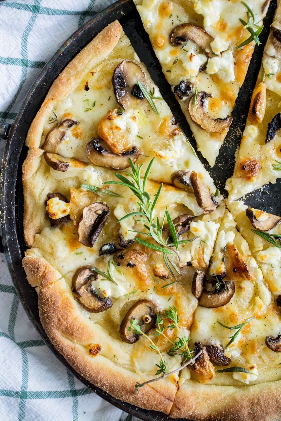 Mushroom pizza bianco with truffle oil and fresh herbs